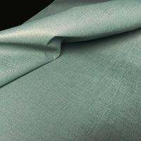 Close-up view of Waterproof Fabric Backed Commercial Wallcovering in Meadow Green, showcasing a heavy-duty, industrial textile texture with a luminous metallic sheen and vibrant green accents on a durable vinyl surface.