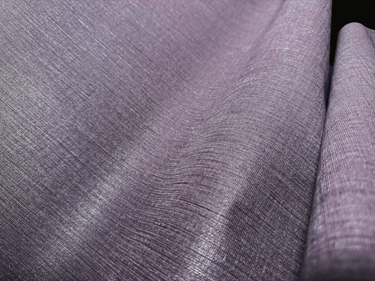 A high-resolution macro detail of Dusky Lavender Waterproof Wallcovering, highlighting the industrial linen-weave emboss. The image captures the intricate intersection of muted heather and soft slate threads, showcasing a high-tactile, shimmering surface designed for heavy-duty commercial durability.