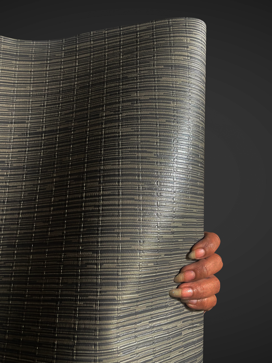 Close-up view of Waterproof Fabric Backed Commercial Wallcovering in Cosmic Grey, featuring a structured pattern of horizontal ribs and vertical geometric accents with a deep, light-reflective slate grey luster on a durable vinyl surface.