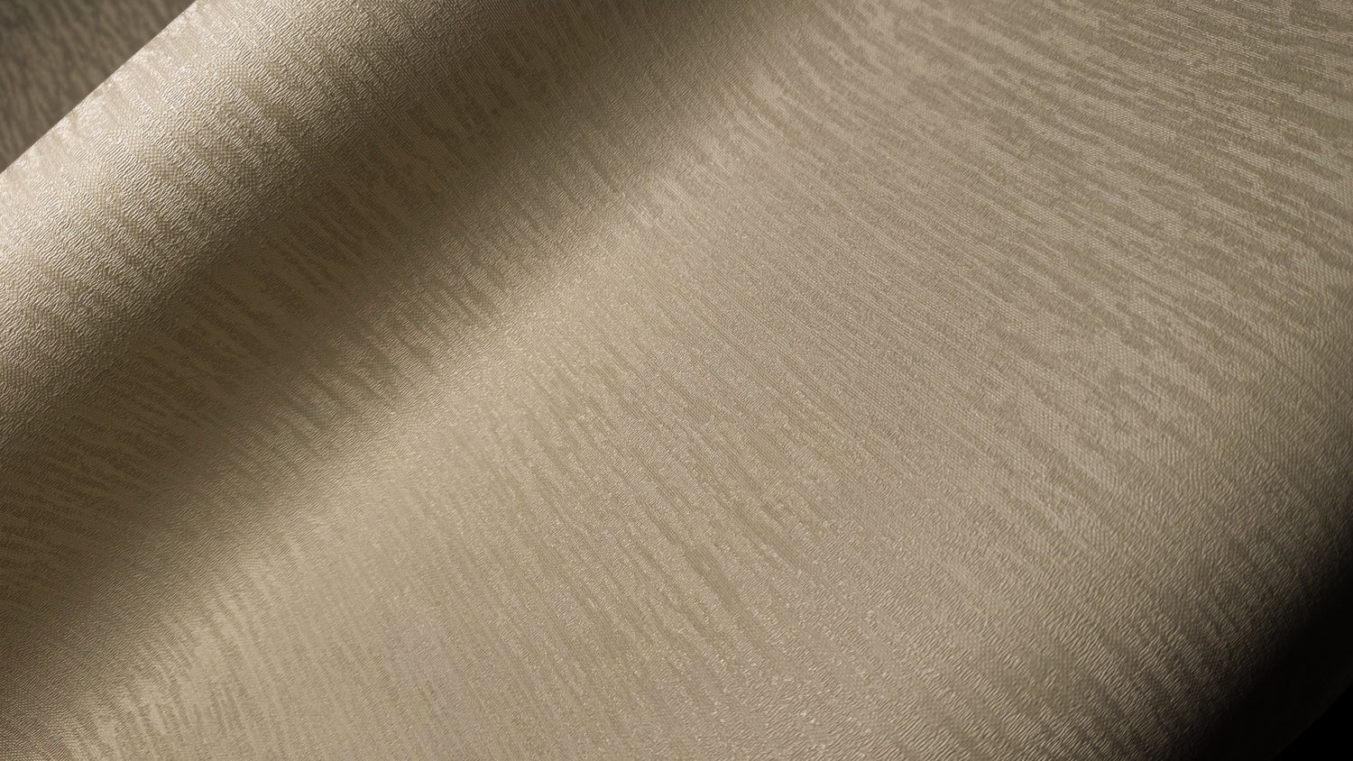 Close-up view of Waterproof Fabric Backed Commercial Wallcovering in Moonlit Beige, featuring a delicate rippled silk texture with a soft metallic luster on a durable vinyl surface.