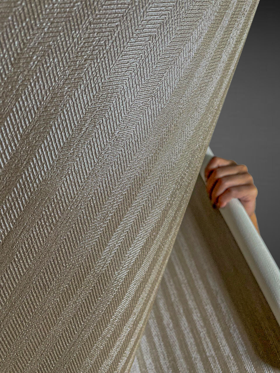 Close-up view of Waterproof Fabric Backed Commercial Wallcovering in Ash Brown, featuring a detailed herringbone weave and a durable, moisture-resistant vinyl surface for professional interiors.