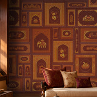 The Royal Rajputana Courtyard wallpaper in Imperial Burgundy featuring intricate Rajasthani palace-inspired motifs, elephant illustrations, floral artwork, Mughal arches, and antique gold detailing in a luxurious heritage-style living room.
