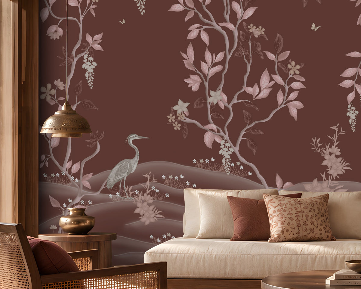 Timeless Avian Garden Mural in rich burgundy brown featuring delicate pink botanical branches, graceful birds, soft floral details, and flowing foliage. The elegant nature-inspired wallpaper creates a warm and sophisticated living room with neutral seating, dark wood furniture, natural textures, and soft ambient lighting.