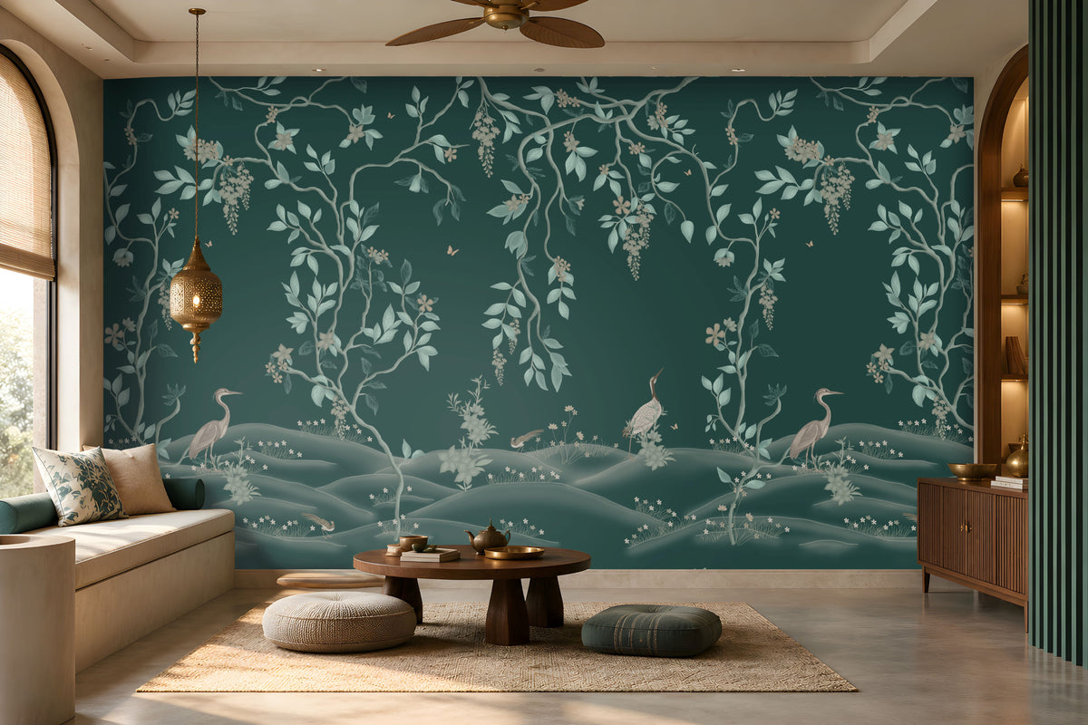 Luxurious living room featuring a teal botanical wallpaper mural with delicate vines, foliage, blossoms, and graceful birds, complemented by a neutral sofa, wooden coffee table, textured rug, warm pendant lighting, and elegant wooden cabinetry.
