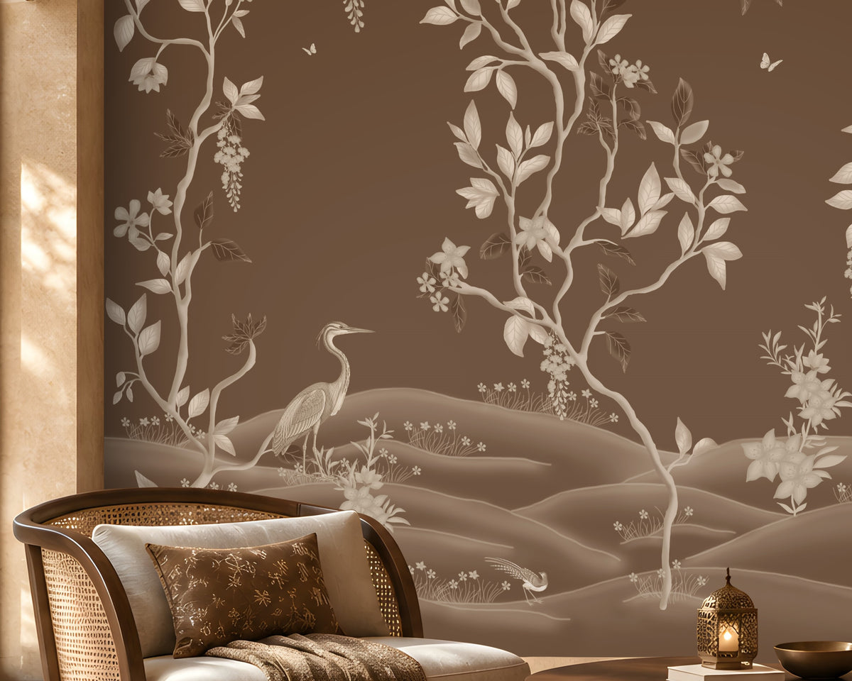 Warm brown botanical wallpaper mural featuring delicate ivory vines, leaves, blossoms, and elegant birds, styled in a luxurious living room with natural wood furniture, a cane accent chair, soft neutral seating, a textured rug, warm ambient lighting, and refined earthy décor.
