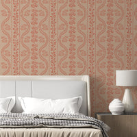 A high-resolution detail of the Floral Seamless Wallpaper in Toasted Almond, showcasing the rhythmic, S-curve vine structure and delicate botanical sprigs. The image highlights the fine, hand-drawn illustrative style and the soothing, earthy tones of the tan, ochre, and warm cream palette.