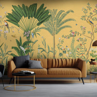 An architectural perspective of a sophisticated lounge featuring the Tropical Jungle Haven Mural in Mellow Yellow as a full-scale feature wall. The mural’s detailed wildlife narrative pairs elegantly with warm wood furniture and natural sunlight, creating a grand and cultured interior sanctuary.