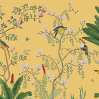 An architectural perspective of a sophisticated lounge featuring the Tropical Jungle Haven Mural in Mellow Yellow as a full-scale feature wall. The mural’s detailed wildlife narrative pairs elegantly with warm wood furniture and natural sunlight, creating a grand and cultured interior sanctuary.