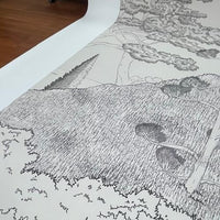 An architectural perspective of a contemporary reading nook featuring the Tropical Landscape Mural in Stone Gray as a full-scale feature wall. The mural’s detailed, monochromatic design pairs elegantly with slate-gray upholstery and natural stone accents, creating a grounded and cultured interior.