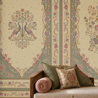 Vanamala Garden Mural Wallpaper - Antique Olive Green featuring elegant peacock motifs, floral bouquets, and ornate heritage-inspired frames in soft dusky teal blue and ivory tones, showcased in a luxurious Indian living room with carved wooden furniture, warm lighting, and classic decorative accents.