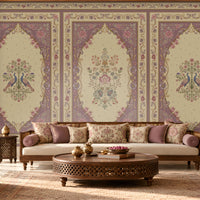 Vanamala Garden Mural Wallpaper - Muted Plum featuring graceful peacock motifs, delicate floral bouquets, and ornate heritage-inspired borders in soft dusky teal blue and ivory tones, showcased in an elegant Indian living room with carved wooden furniture and traditional décor.