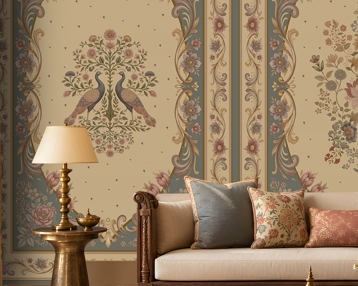 Vanamala Garden Mural Wallpaper - Slate Blue showcasing ornate peacock motifs, intricate floral medallions, and decorative heritage borders in dusky teal blue and ivory tones, styled in a luxurious traditional living room with carved wooden furniture, soft furnishings, and warm natural lighting.