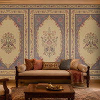 Vanamala Garden Mural Wallpaper - Dusky Lilac displayed in a traditional Indian living room, featuring elegant peacock motifs, intricate floral artwork, ornate heritage frames, and decorative borders in dusky teal blue and soft ivory tones, creating a luxurious palace-inspired interior ambiance.