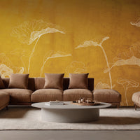 An architectural perspective of a contemporary luxury lounge featuring the Veins of Nature Mural in Sunset Gold as a full-scale backdrop behind a leather sectional sofa. The mural’s vertical composition and luminous color create a sense of warmth and expansive space, pairing elegantly with natural stone flooring and modern designer furniture.