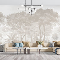 An architectural perspective of a sunlit beachside lounge featuring the Vintage Tropics Mural in Whispering Beige as a full-scale backdrop behind a light wood sectional sofa. The mural’s expansive forest scene pairs elegantly with natural jute rugs, light-toned wooden furniture, and a bright, airy coastal environment.