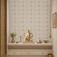 A serene Indian pooja room alcove or mandir backdrop featuring a beige Vraj Kamal Pichwai wallpaper patterned with cows and pink lotuses, styled with a Ganesha idol on a marble altar console and elegant brass fixtures.