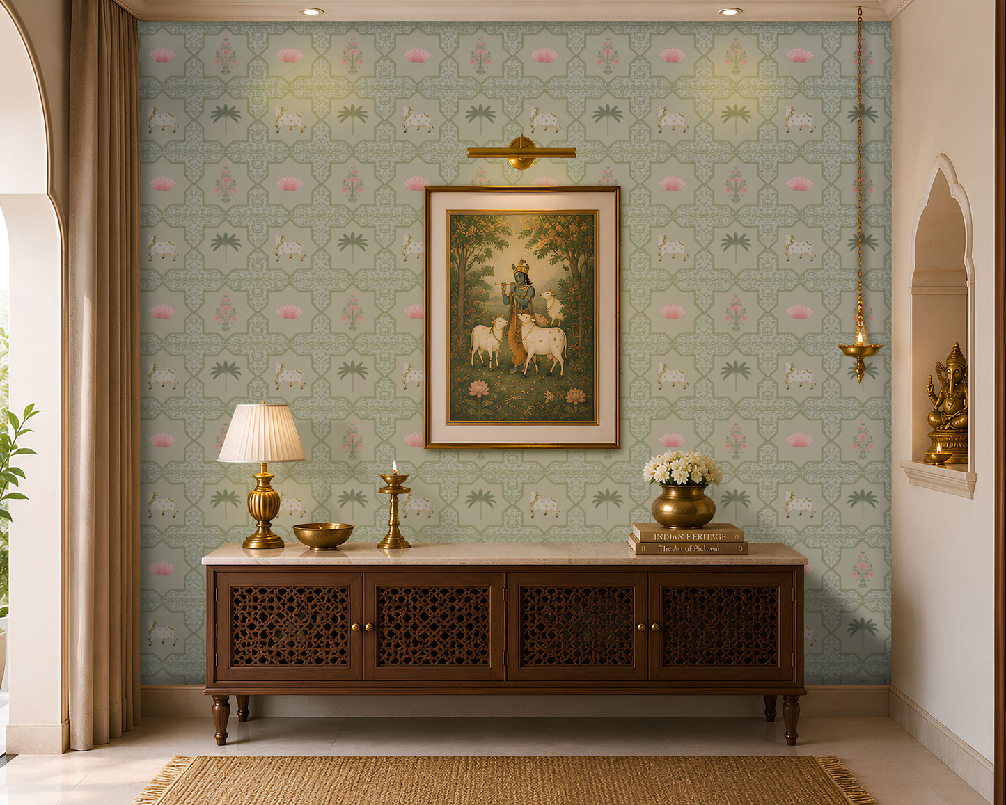 A luxurious Indian-style living room or pooja room foyer featuring a sage green Vraj Kamal Pichwai wallpaper patterned with cows and pink lotuses, styled with a wooden console table, a traditional Lord Krishna painting, and gold accents.