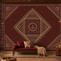Warli Print Wallpaper in earthy and deep maroon featuring traditional tribal figures, village motifs and geometric patterns in an Indian-inspired living room.