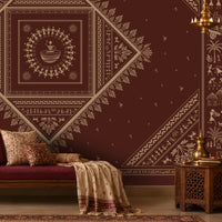Warli Print Wallpaper in earthy and deep maroon featuring traditional tribal figures, village motifs and geometric patterns in an Indian-inspired living room.