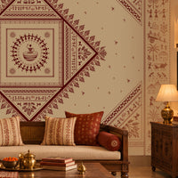 A styled living room featuring a large decorative wall mural with a central diamond-shaped mandala pattern in deep red and beige. The room is furnished with a wooden sofa, matching armchairs, a carved wooden coffee table, and warm ambient lighting.