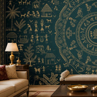 A styled living room featuring a large dark teal wall mural with intricate cream-colored Indian folk art motifs, including a central mandala and figures. The room is furnished with a cream sofa, a dark wood coffee table, a matching area rug, and accent chairs.
