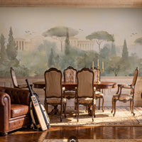 An architectural perspective of a grand traditional dining room featuring the Whispers of Rome Floral Mural as a full-scale panoramic backdrop. The mural’s soft, atmospheric colors create a sophisticated "framed view" that pairs perfectly with classic leather chesterfield seating, antique wooden furniture, and ornate wainscoting.