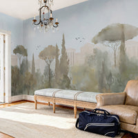 An architectural perspective of a grand traditional dining room featuring the Whispers of Rome Mural in Sky Blue as a full-scale panoramic backdrop. The mural’s soft, atmospheric colors create a sophisticated "framed view" that pairs perfectly with classic leather chesterfield seating, antique wooden furniture, and light-filled interiors.