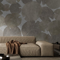A high-resolution detail of the Whispers of the Pond Nature Wallpaper, showcasing the intricate, lace-like skeletal structures and detailed veining of the overlapping lily pads. The image highlights the sophisticated interplay between the cool silver-toned leaf patterns and the light, textured background.