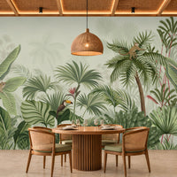 Wildwood Reverie- soft olive green botanical wallpaper mural featuring lush tropical foliage, oversized palm leaves, exotic birds, playful monkeys, and delicate floral details against a soft sage and soft-green background, ideal for creating a refreshing tropical-inspired interior.