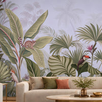 Artistic jungle mural illustration featuring various tropical plants and wild animals against a soft, textured grey background. Lush green and sage palm leaves, banana trees, and dense foliage.