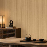 Wood Seamless Wallpaper - Champange beige displayed in a sophisticated Japandi-inspired dining space. The wallpaper features a warm almond beige base with subtle vertical wood grain detailing, creating a seamless and natural wall finish. Complemented by rich walnut-toned furniture, soft ambient lighting, decorative shelving, and minimalist décor accents, the wallpaper enhances the room with warmth, texture, and timeless elegance while maintaining a calm and contemporary aesthetic.