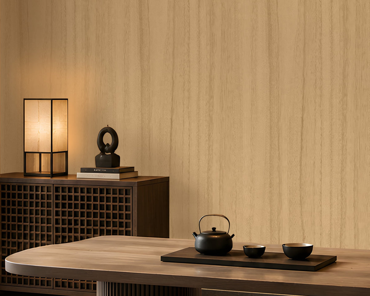 Wood Seamless Wallpaper - Champange beige displayed in a sophisticated Japandi-inspired dining space. The wallpaper features a warm almond beige base with subtle vertical wood grain detailing, creating a seamless and natural wall finish. Complemented by rich walnut-toned furniture, soft ambient lighting, decorative shelving, and minimalist décor accents, the wallpaper enhances the room with warmth, texture, and timeless elegance while maintaining a calm and contemporary aesthetic.