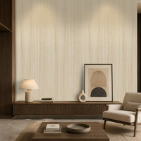 Wood Seamless Wallpaper - Desert Ivory featured in a modern minimalist living room. The wallpaper showcases a soft almond beige tone with subtle vertical wood grain texture, creating a warm and elegant backdrop. Paired with dark wood furniture, neutral décor, ambient lighting, and contemporary accents, the design adds natural warmth, depth, and sophistication to the interior space.
