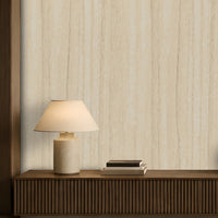 Wood Seamless Wallpaper - Desert Ivory featured in a modern minimalist living room. The wallpaper showcases a soft almond beige tone with subtle vertical wood grain texture, creating a warm and elegant backdrop. Paired with dark wood furniture, neutral décor, ambient lighting, and contemporary accents, the design adds natural warmth, depth, and sophistication to the interior space.