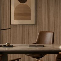 Wood Seamless Wallpaper - Espresso Brown displayed in a contemporary home office featuring a warm almond-beige wood grain texture with seamless vertical patterns. The wallpaper creates a sophisticated backdrop for dark wood shelving, leather seating, modern artwork, and ambient lighting, adding natural warmth, depth, and elegance to the workspace.