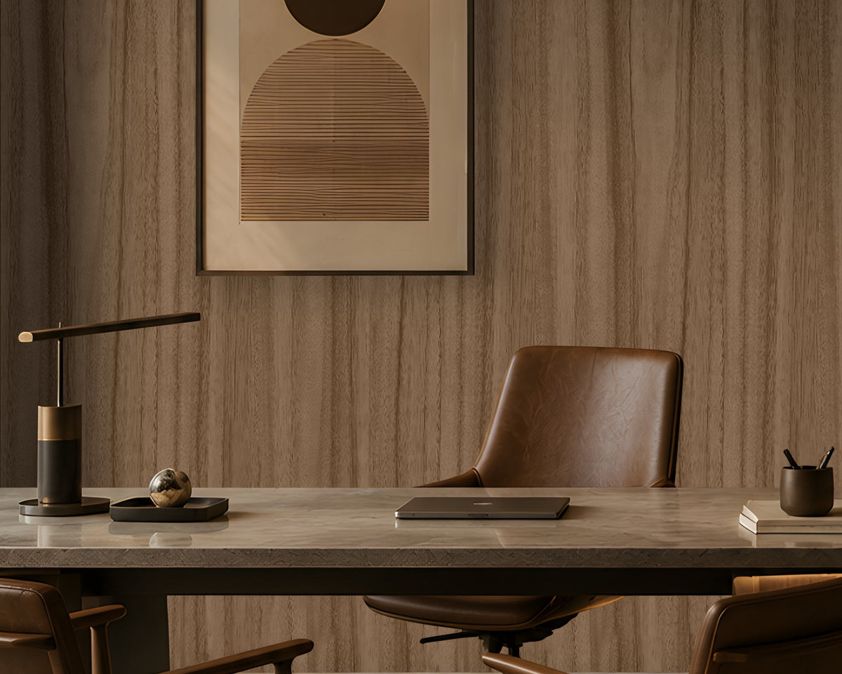 Wood Seamless Wallpaper - Espresso Brown displayed in a contemporary home office featuring a warm almond-beige wood grain texture with seamless vertical patterns. The wallpaper creates a sophisticated backdrop for dark wood shelving, leather seating, modern artwork, and ambient lighting, adding natural warmth, depth, and elegance to the workspace.