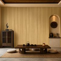 Wood Seamless Wallpaper - Golden Beige displayed in a serene Japandi-inspired living space. The wallpaper features a warm golden beige tone with delicate vertical wood grain textures, creating a seamless and natural backdrop. Paired with dark wood furniture, floor cushions, decorative pottery, ambient lighting, and earthy accents, the design brings warmth, texture, and timeless elegance to the interior.