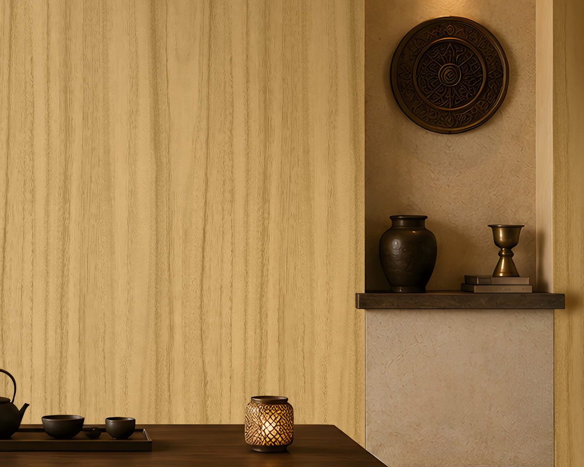 Wood Seamless Wallpaper - Golden Beige displayed in a serene Japandi-inspired living space. The wallpaper features a warm golden beige tone with delicate vertical wood grain textures, creating a seamless and natural backdrop. Paired with dark wood furniture, floor cushions, decorative pottery, ambient lighting, and earthy accents, the design brings warmth, texture, and timeless elegance to the interior.