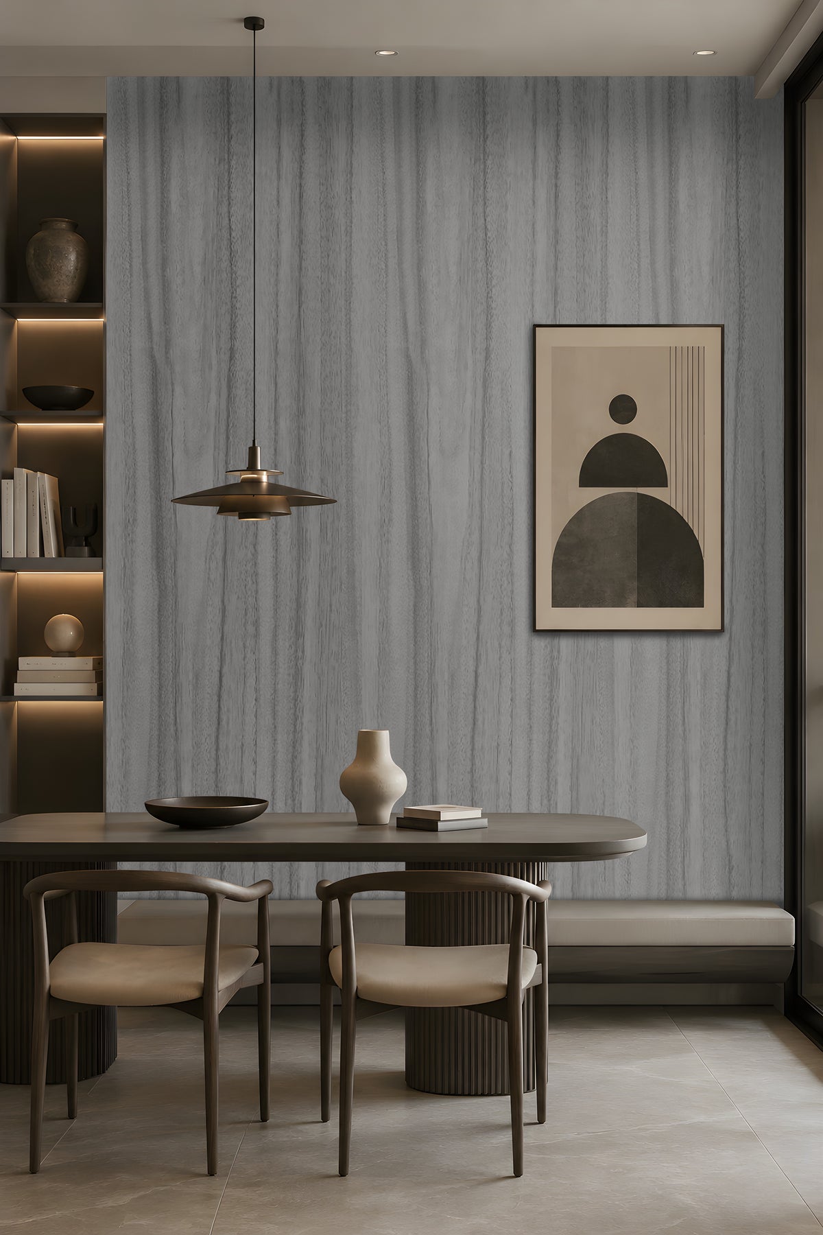 Wood Seamless Wallpaper - Textured Ash Grey featured in a modern dining space. The wallpaper showcases a sophisticated ash grey tone with seamless vertical wood grain textures, creating a refined and contemporary backdrop. Paired with dark wood furniture, warm ambient lighting, built-in shelving, and minimalist décor, the design adds depth, texture, and understated elegance to the interior while maintaining a calm and modern aesthetic.