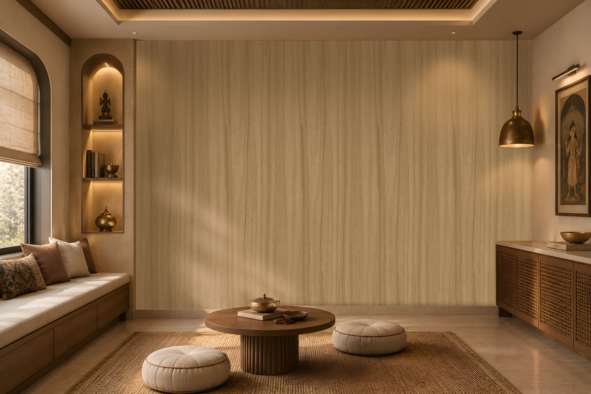 Wood Seamless Wallpaper - Wheat Cream displayed in a cozy contemporary interior. The wallpaper features a warm wheat cream tone with subtle vertical wood grain textures, creating a soft and natural backdrop. Complemented by warm ambient lighting, wooden accents, decorative shelving, and neutral furnishings, the design brings a sense of depth, comfort, and understated elegance to the space.