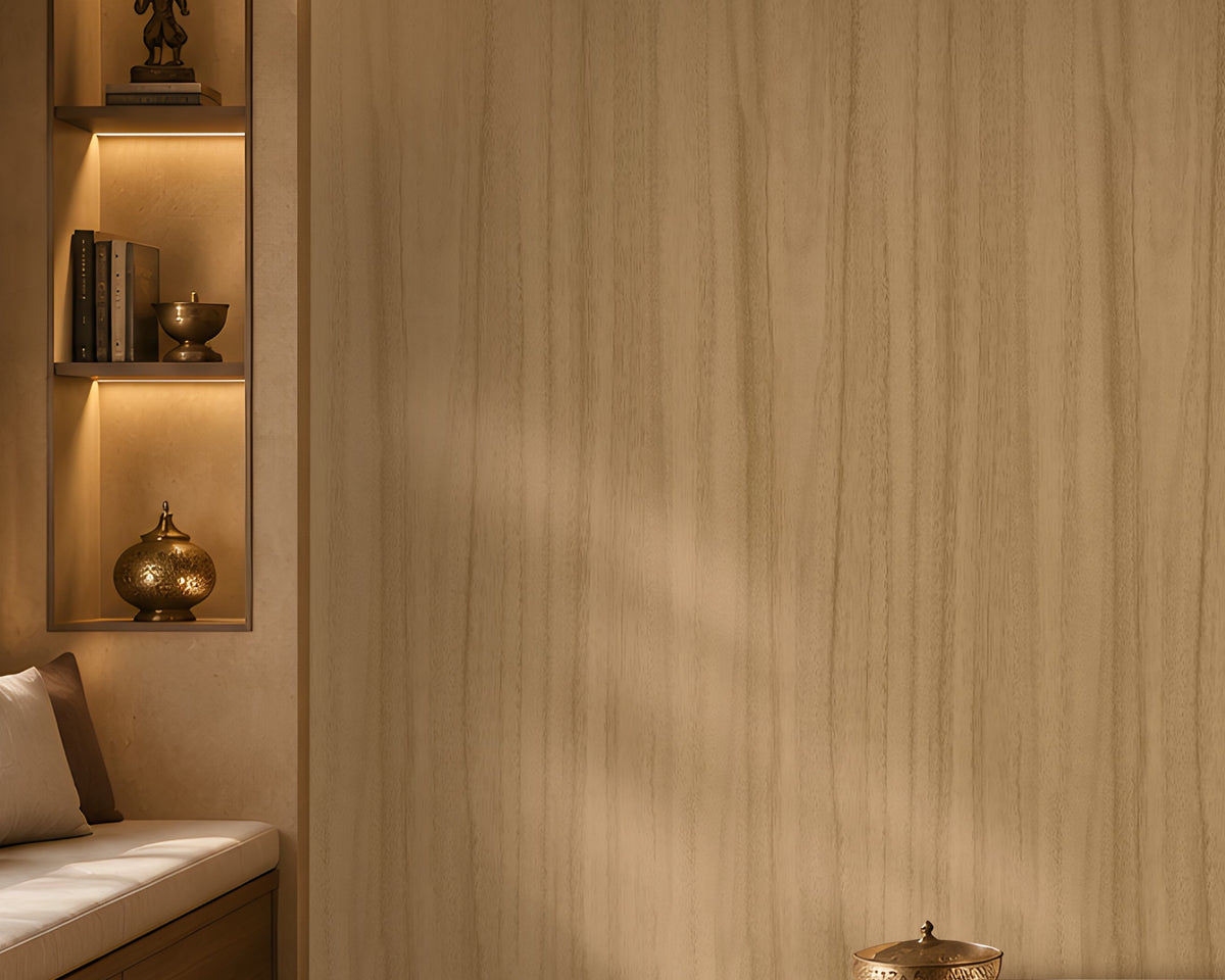 Wood Seamless Wallpaper - Wheat Cream displayed in a cozy contemporary interior. The wallpaper features a warm wheat cream tone with subtle vertical wood grain textures, creating a soft and natural backdrop. Complemented by warm ambient lighting, wooden accents, decorative shelving, and neutral furnishings, the design brings a sense of depth, comfort, and understated elegance to the space.